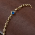 Silver Bracelet in Gold Color with Interlocking Rings Design Studded with Blue Eye Stone