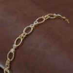 Gold-Tone Silver Bracelet with Interlocking Rings and Infinity Design